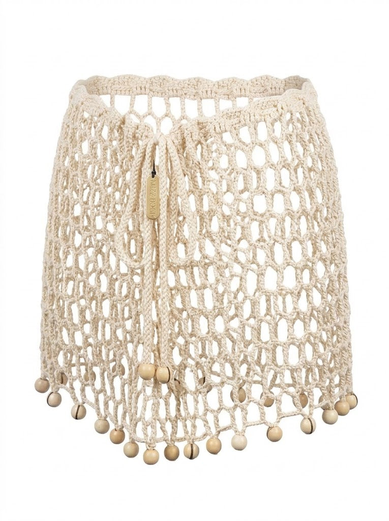 Minifalda ARUMA beige artesanal con calado abierto y cintura ajustable.