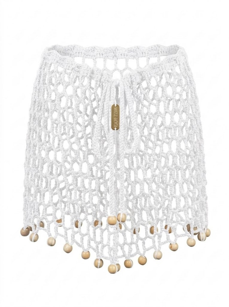 Minifalda ARUMA blanca sin modelo, tejida en crochet calado con cuentas decorativas y cordones ajustables.