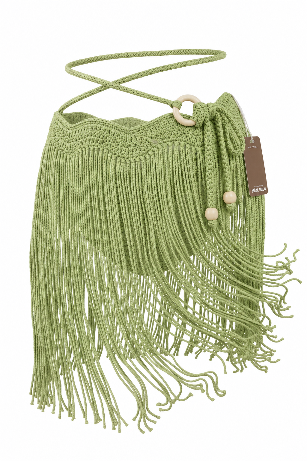 Falda MINI TASSEL OLAS pistacho sin modelo, con pretina de ondas tejida a mano, flecos largos, tiras ajustables y aro lateral en tono madera clara.